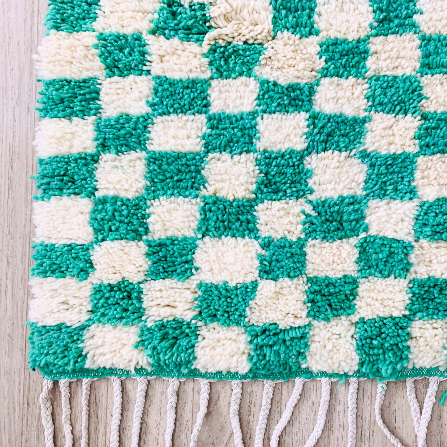edge-of-green-and-white-checkered-rug