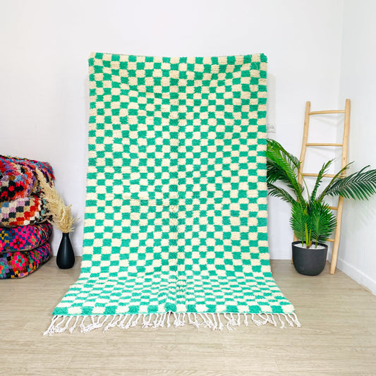 moroccan-green-and-white-checkered-rug-hanging-on-apartment-in-Los-angeles-California-usa